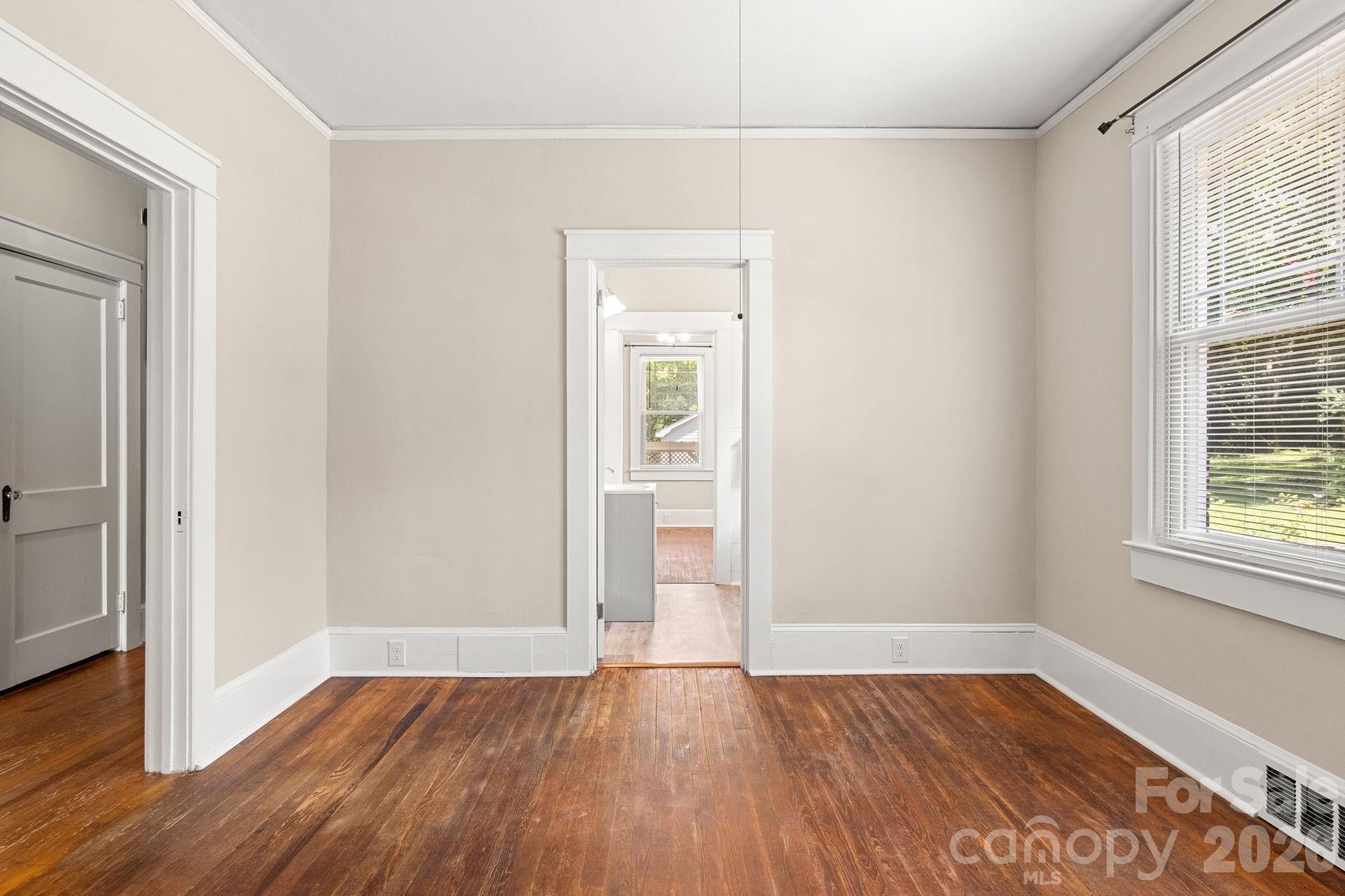 108 Reedy Street Chester, SC 29706 - Photo 26 of 42 an empty room with wooden floor and windows