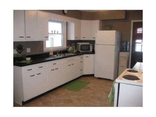 733 Heal Road Malta, IL 60150 - Photo 4 of 11 a kitchen with sink a refrigerator and white cabinets