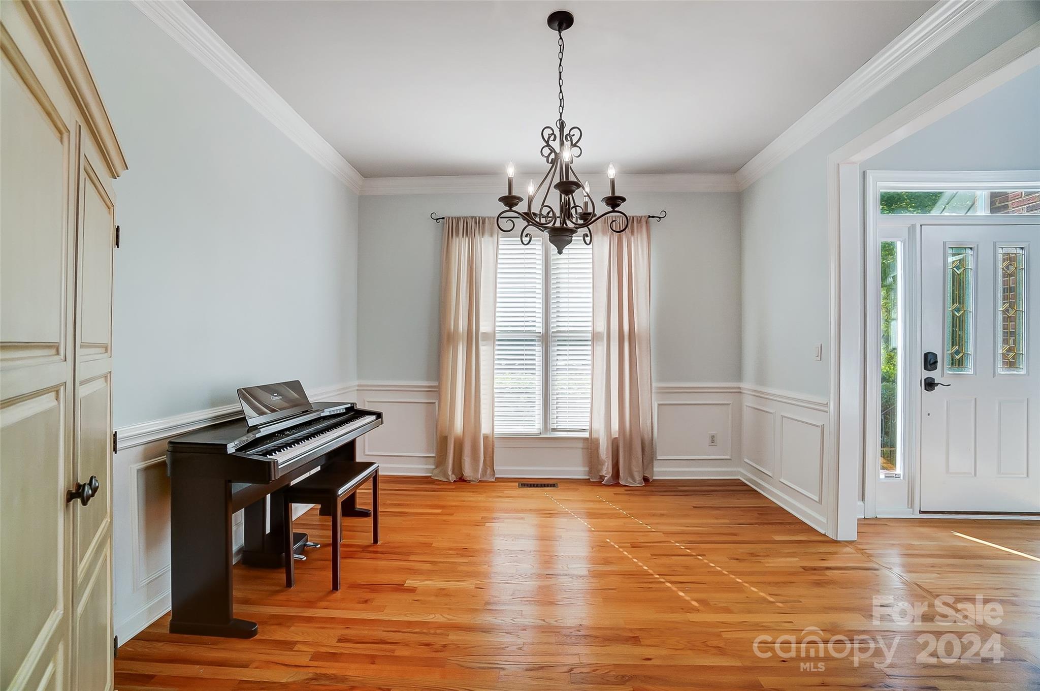 15110 MacBeth Court Huntersville, NC 28078 - Photo 11 of 36 a view of a room with a piano and wooden floor