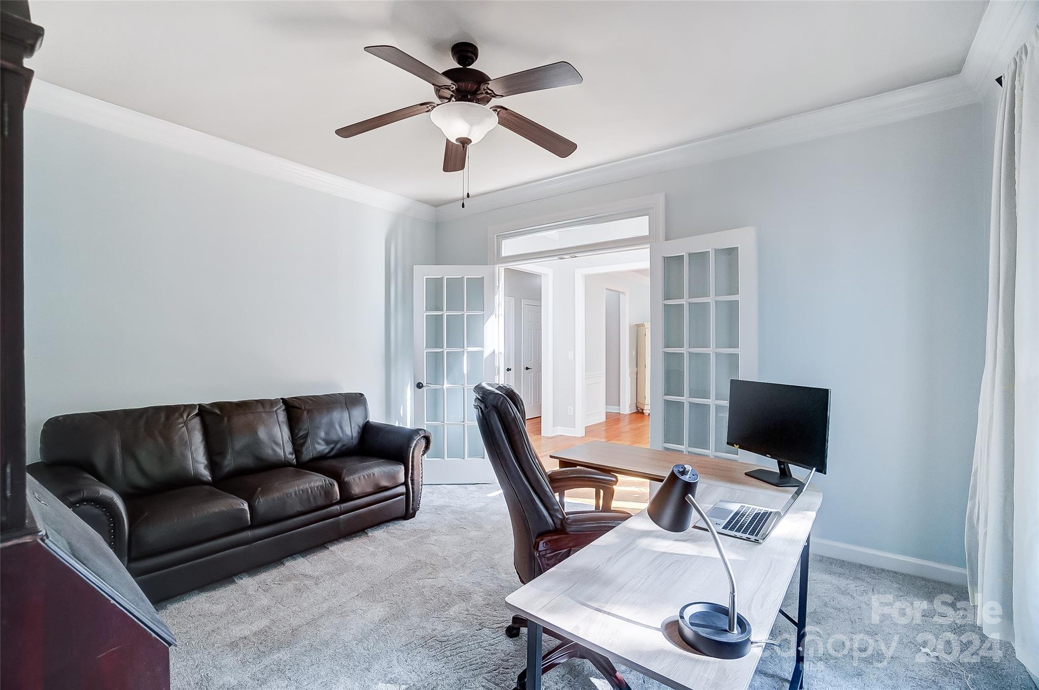 15110 MacBeth Court Huntersville, NC 28078 - Photo 13 of 36 a living room with furniture a ceiling fan a rug and a window