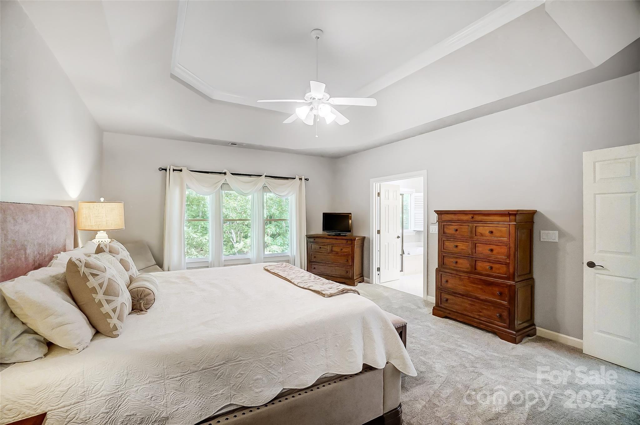 15110 MacBeth Court Huntersville, NC 28078 - Photo 16 of 36 a large bedroom with a bed and a ceiling fan