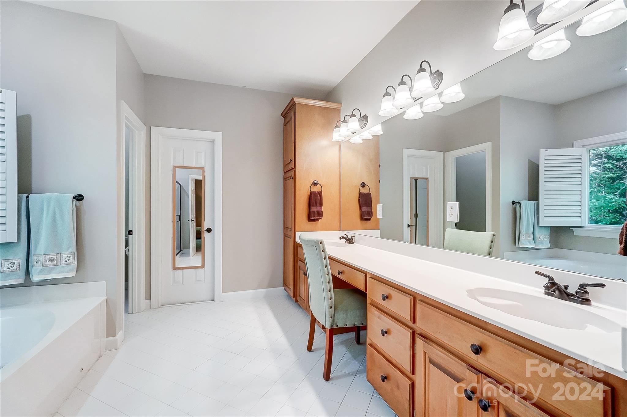 15110 MacBeth Court Huntersville, NC 28078 - Photo 17 of 36 a spacious en suite bathroom with a granite countertop double vanity sink a mirror and a bathtub