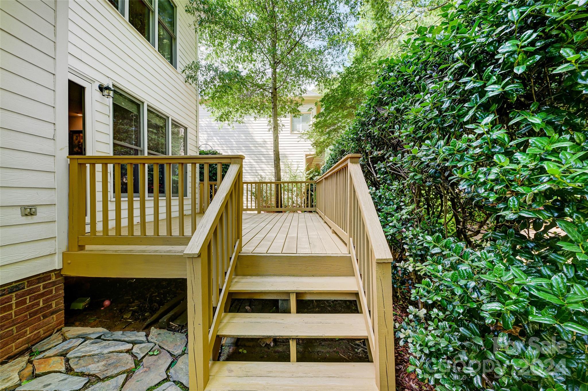 15110 MacBeth Court Huntersville, NC 28078 - Photo 24 of 36 a view of a house with large windows and a small yard