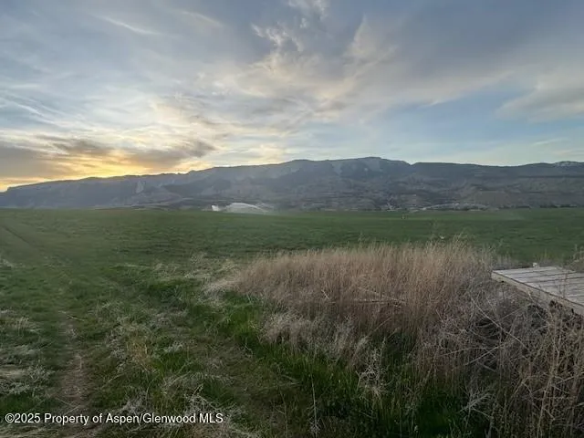 a living room with furniture and floor to ceiling windows