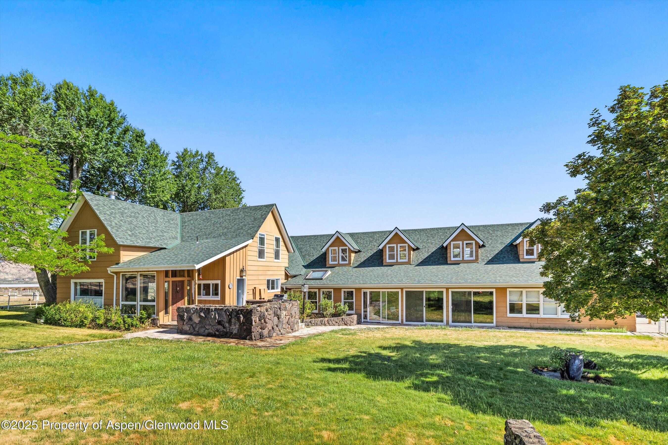 7781 County Road 320 Rifle, CO 81650 - Photo 19 of 63 a view of a house with a big yard potted plants and large tree