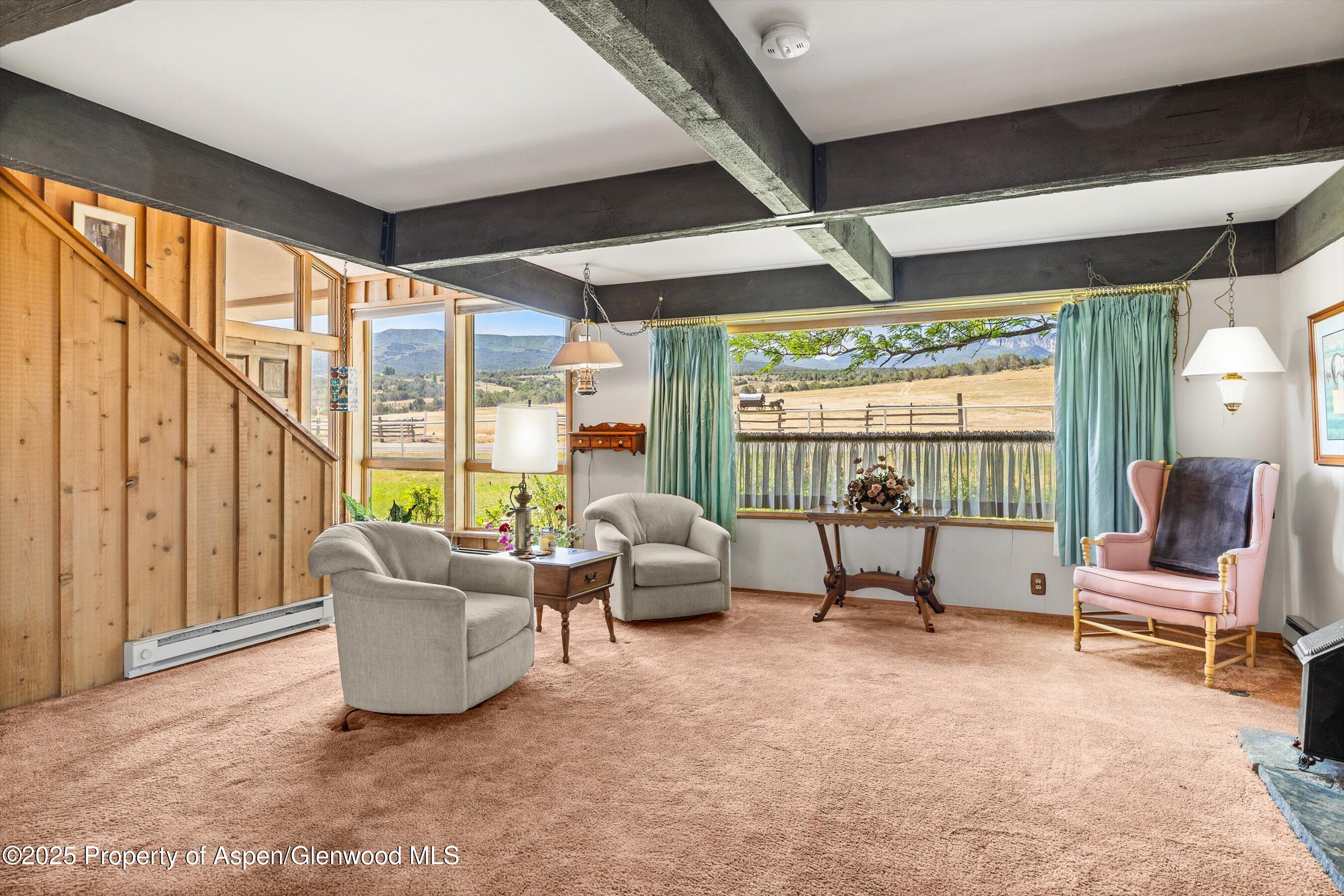 7781 County Road 320 Rifle, CO 81650 - Photo 26 of 63 a living room with furniture and floor to ceiling windows