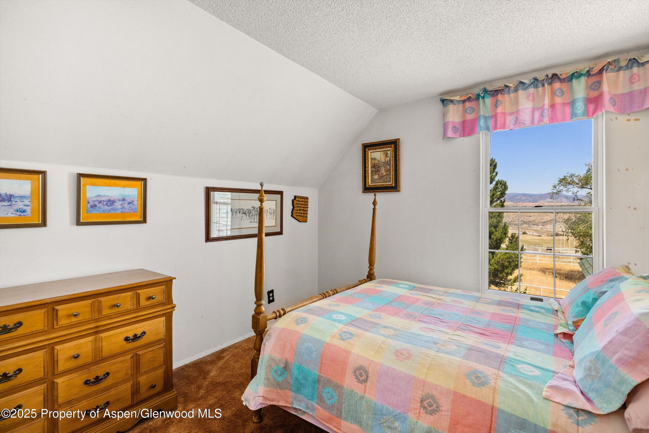 7781 County Road 320 Rifle, CO 81650 - Photo 30 of 63 a bedroom with a bed and a dresser in it
