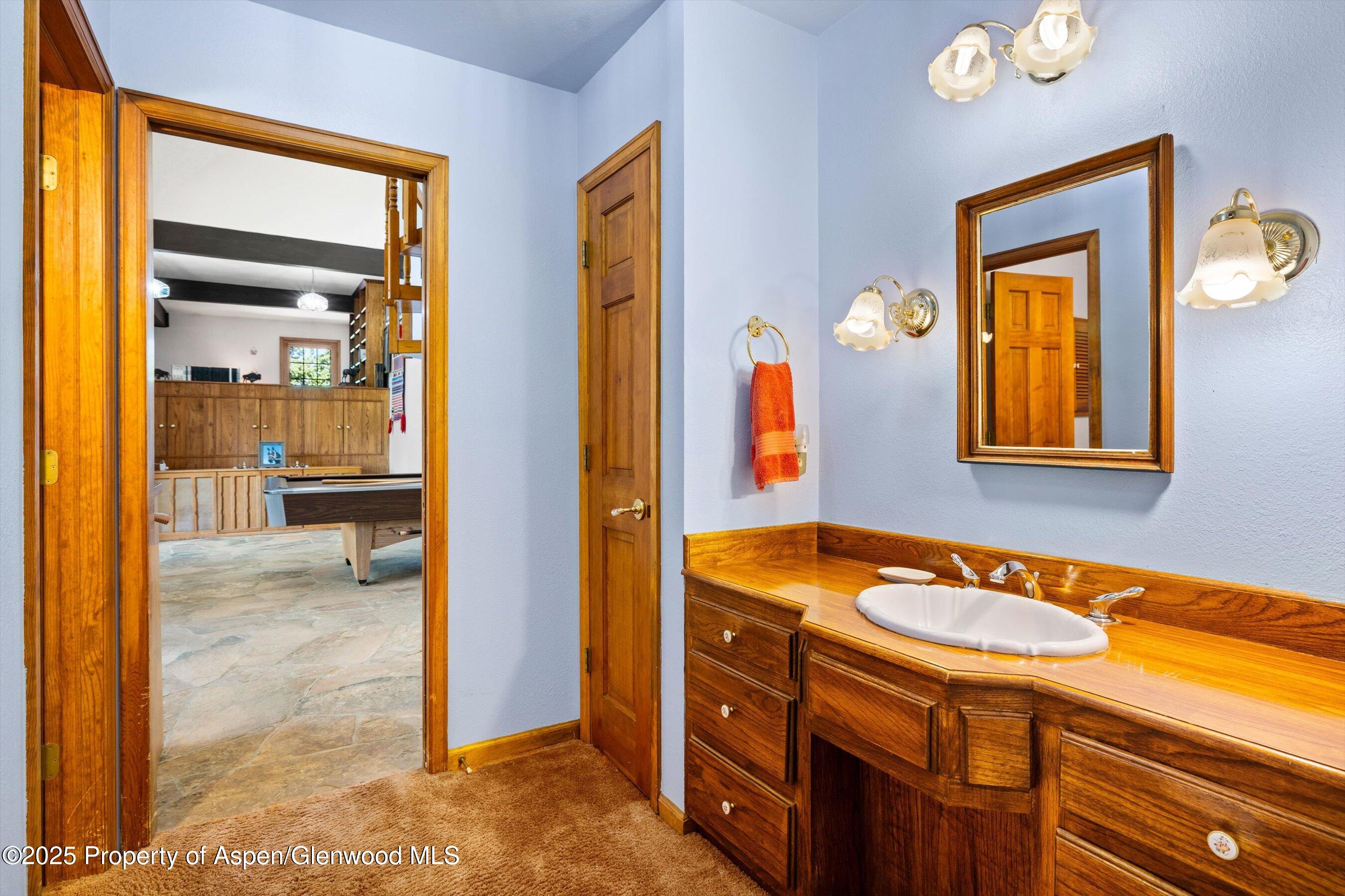 7781 County Road 320 Rifle, CO 81650 - Photo 44 of 63 a bathroom with a granite countertop sink and a mirror