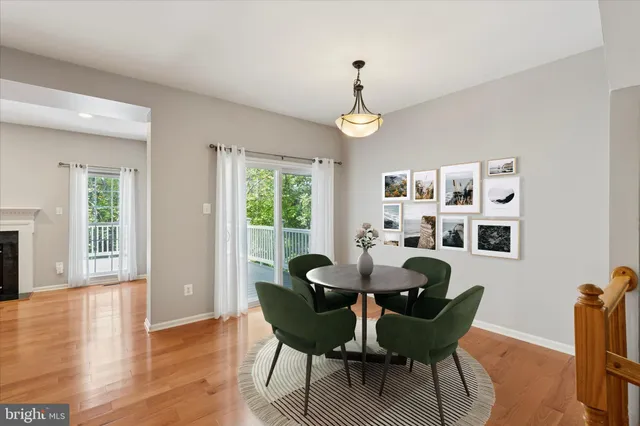 a view of a dining room with furniture a chandelier and wooden floor