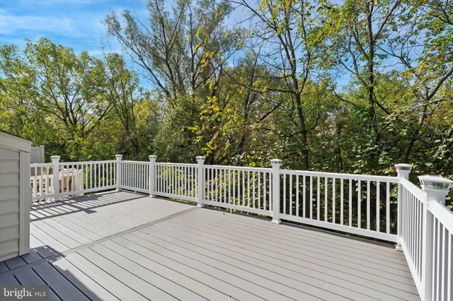 a balcony with wooden floor and fence