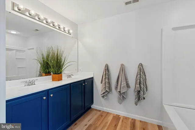 a bathroom with a double vanity sink and a mirror