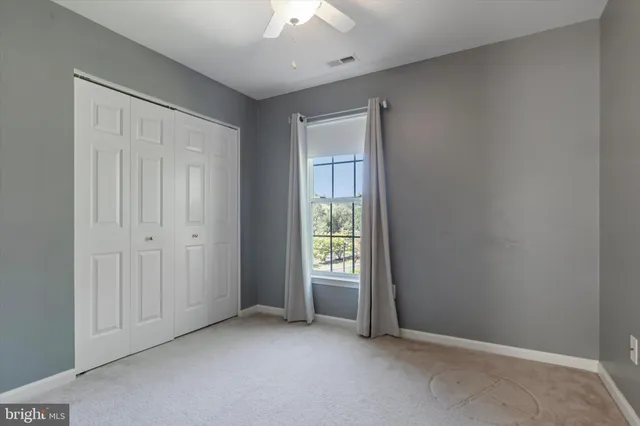 an empty room with windows and closet