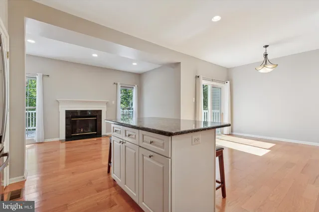 a kitchen with granite countertop a stove and a fireplace