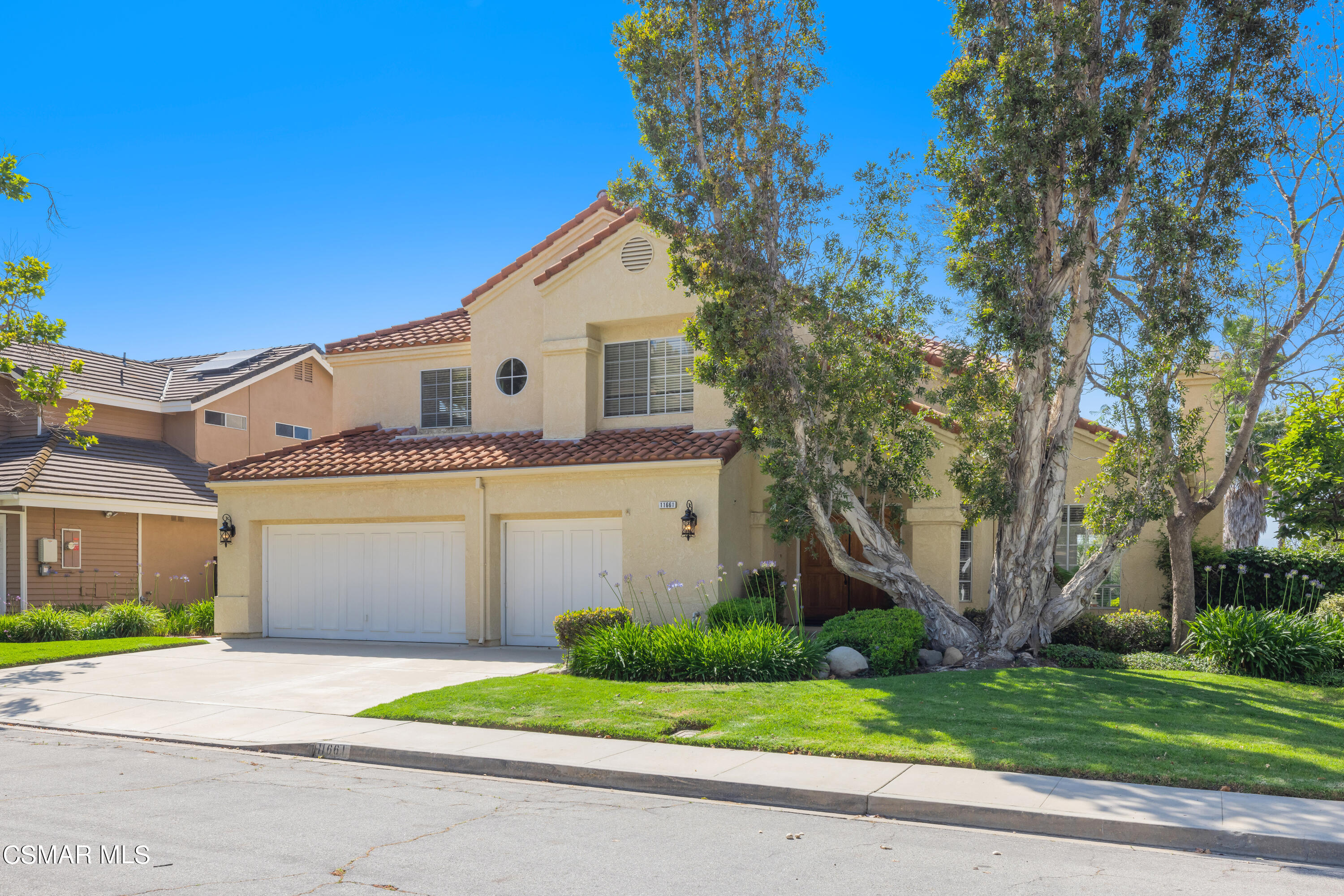 11661 Chestnut Ridge Street Moorpark, CA 93021 - Photo 2 of 39 a front view of a house with a yard and garage