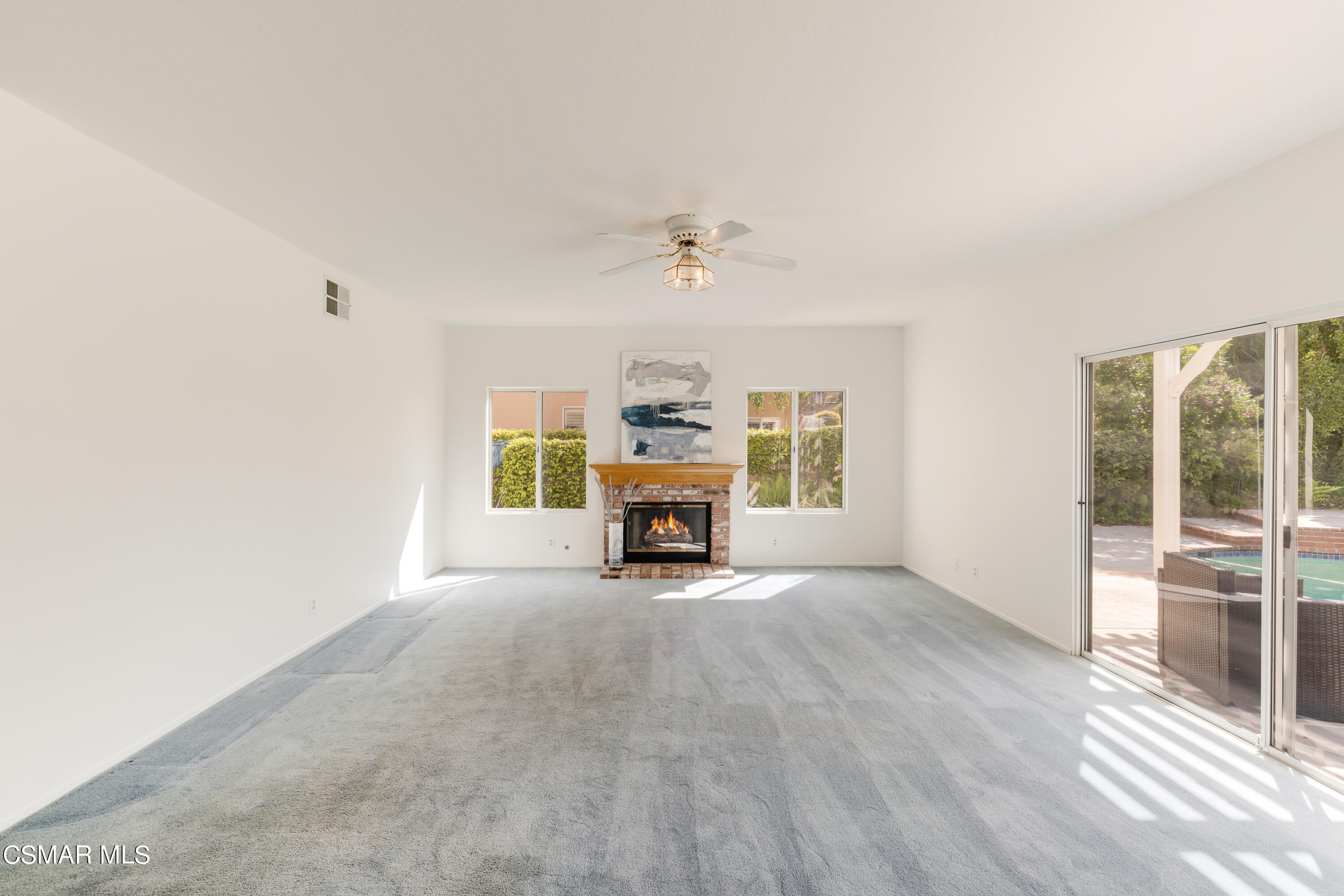 11661 Chestnut Ridge Street Moorpark, CA 93021 - Photo 7 of 39 an empty room with windows and fireplace