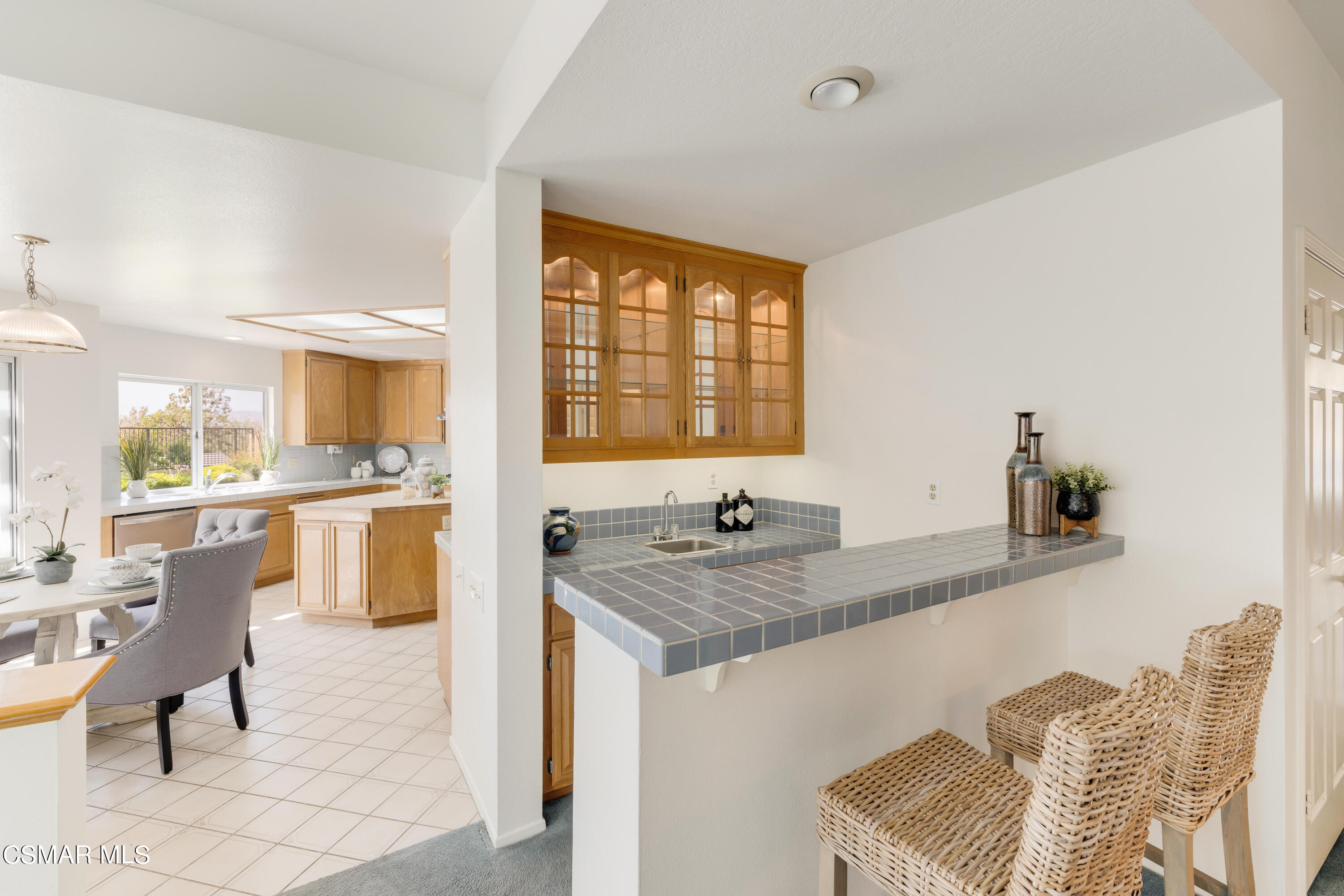 11661 Chestnut Ridge Street Moorpark, CA 93021 - Photo 8 of 39 a kitchen with a sink cabinets and dining table