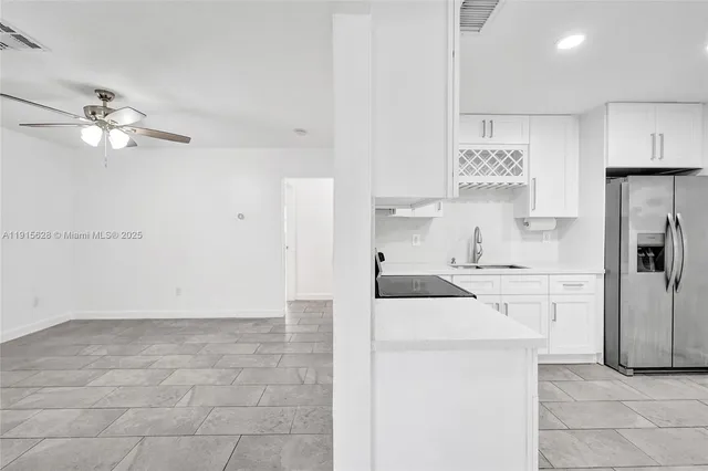 a kitchen with cabinets stainless steel appliances and a counter space