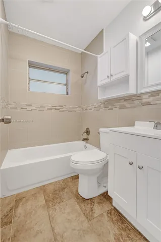 a view of backyard with a barn and a large tree