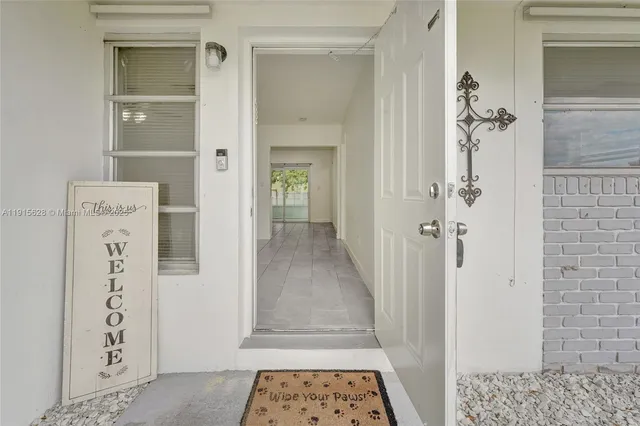 an empty room with white walls and ceiling fan