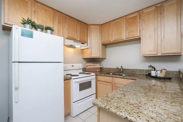 a kitchen with a stove a refrigerator and a dining table