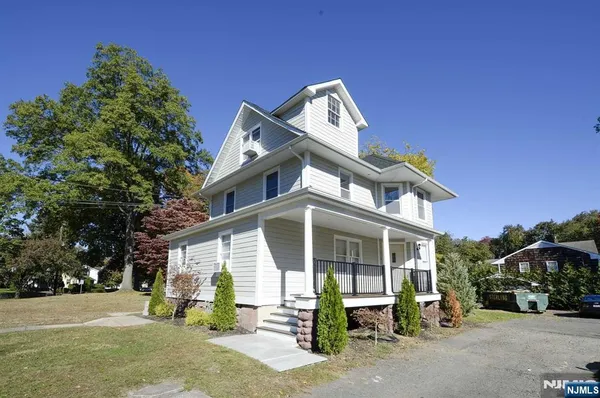 a view of a house with a yard and garage