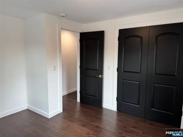 an empty room with wooden floor