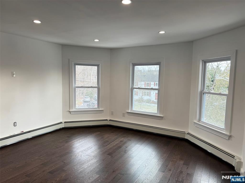 56 Myrtle Avenue, Unit 2 Allendale, NJ 07401 - Photo 6 of 15 an empty room with wooden floor and windows with curtains view