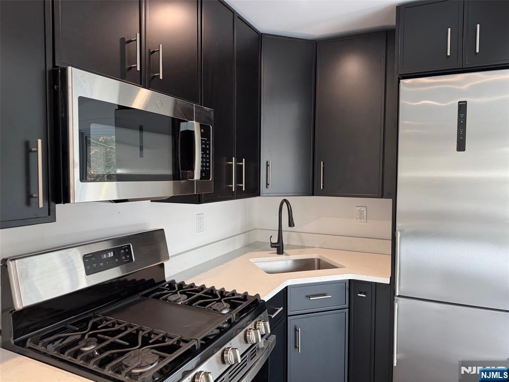56 Myrtle Avenue, Unit 2 Allendale, NJ 07401 - Photo 8 of 15 a kitchen with a stove and a microwave