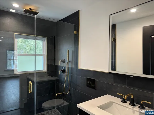 a bathroom with a sink vanity and a mirror