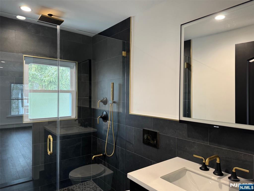 56 Myrtle Avenue, Unit 2 Allendale, NJ 07401 - Photo 9 of 15 a bathroom with a sink vanity and a mirror