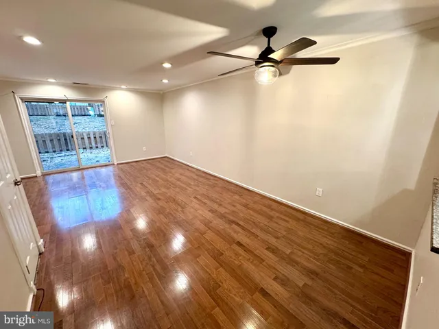 a view of a room with wooden floor and white walls