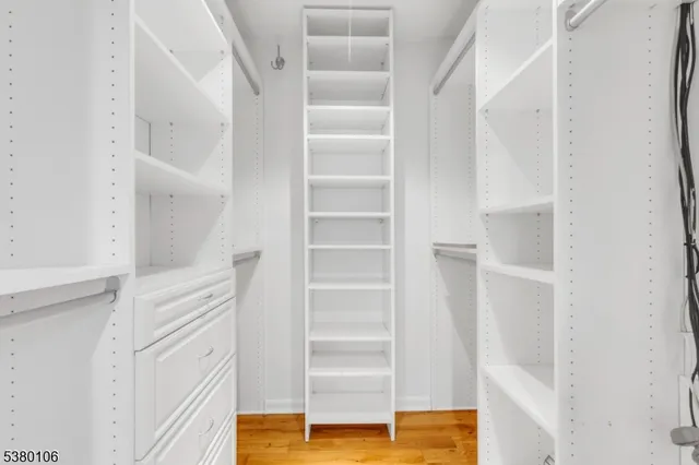 a view of walk in closet with empty racks