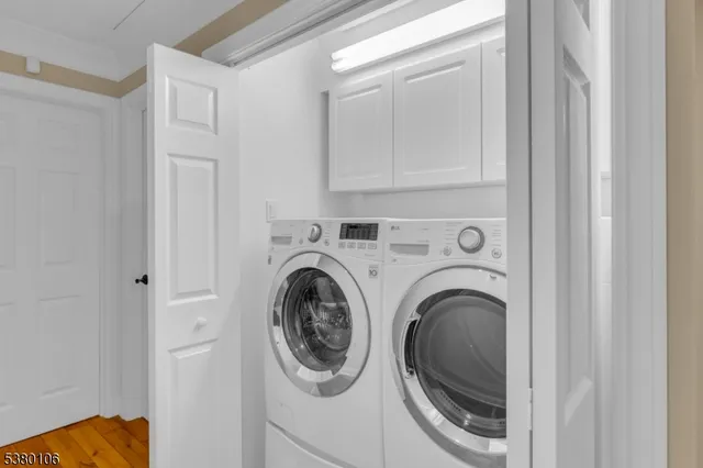 a view of a hallway with washer and dryer