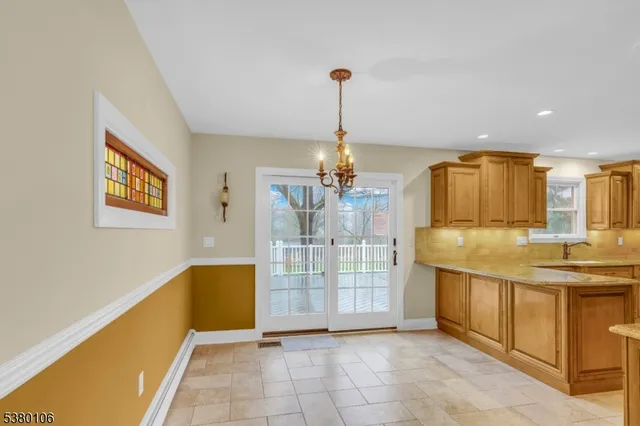 a view of a kitchen with kitchen island a counter top space and stainless steel appliances