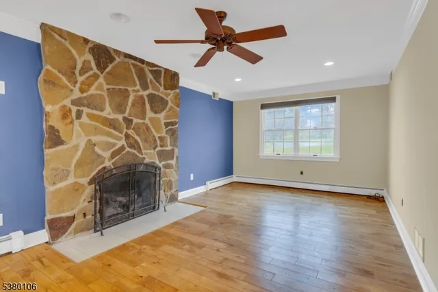 a view of an empty room with a fireplace and a window
