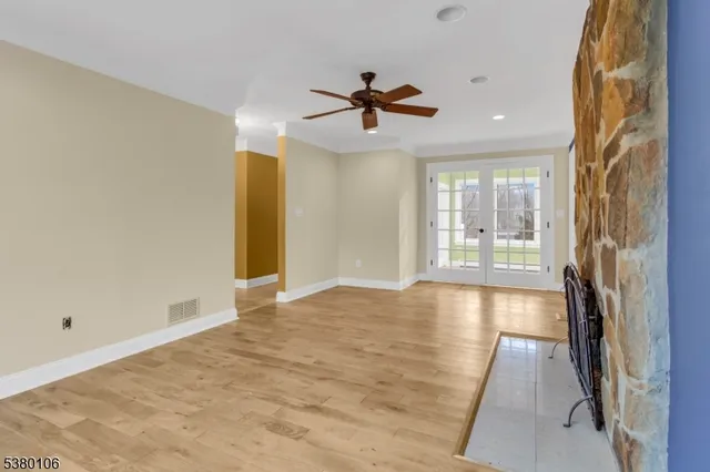 wooden floor in an empty room with a window