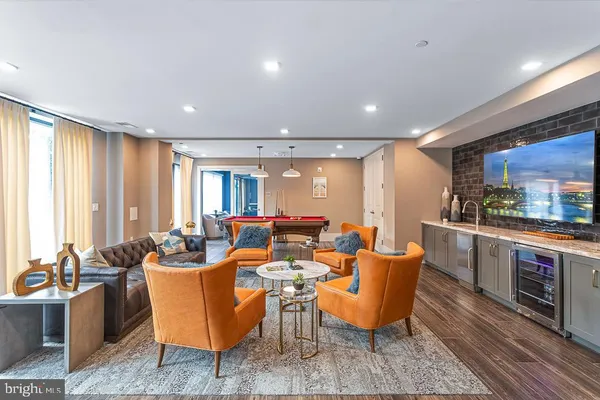 a living room with furniture a large window and a sink