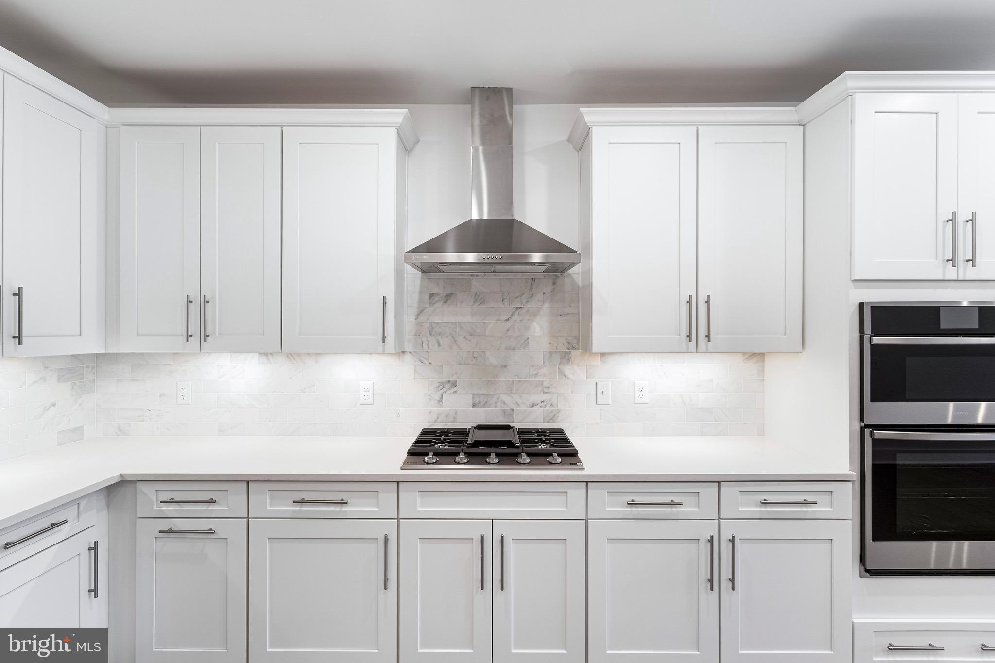 76 Old Mill Bottom Road North, Unit 310 Annapolis, MD 21409 - Photo 18 of 33 a kitchen with white cabinets and stainless steel appliances