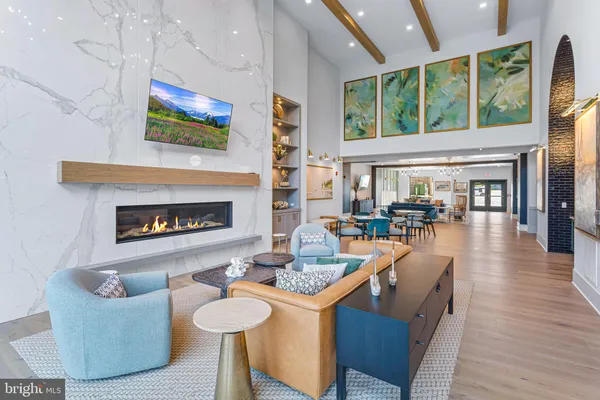 a living room with fireplace furniture and a large window