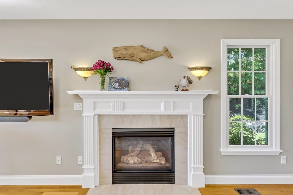 359 Service Road East Sandwich, MA 02537 - Photo 11 of 36 a living room with a fireplace and a flat screen tv