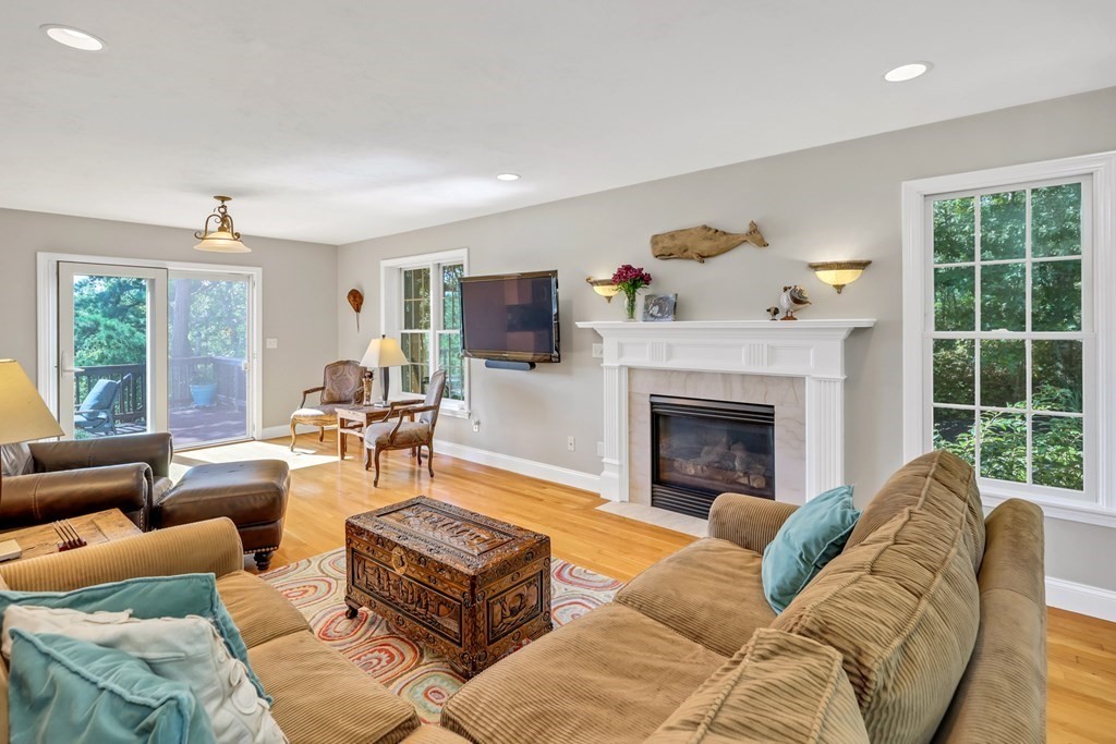 359 Service Road East Sandwich, MA 02537 - Photo 12 of 36 a living room with furniture and a fireplace