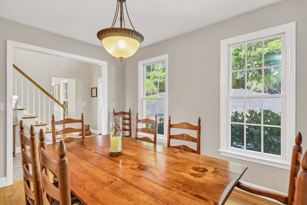 359 Service Road East Sandwich, MA 02537 - Photo 16 of 36 a dining room with wooden floor and a chandelier