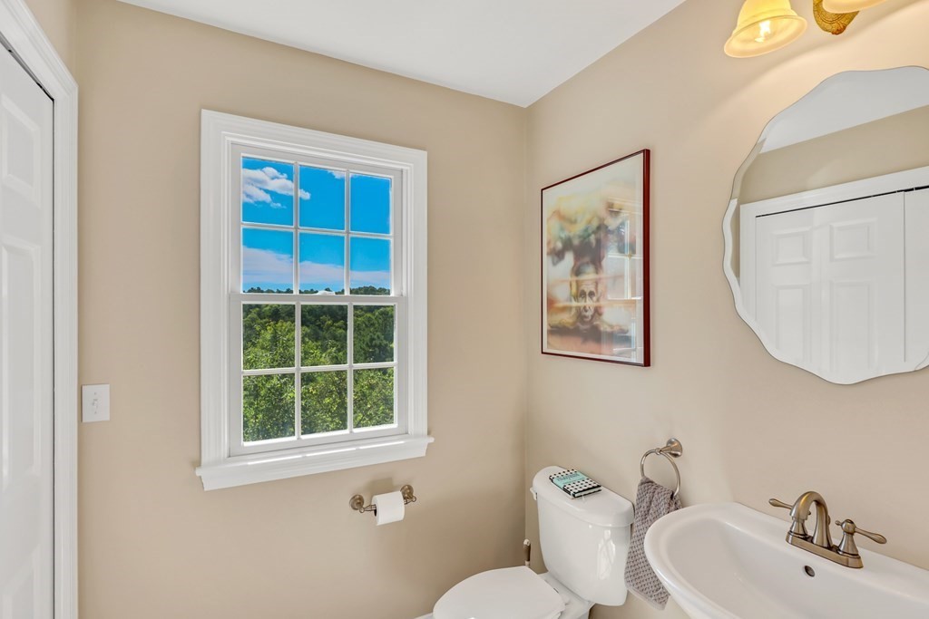 359 Service Road East Sandwich, MA 02537 - Photo 17 of 36 a bathroom with a toilet a sink and mirror