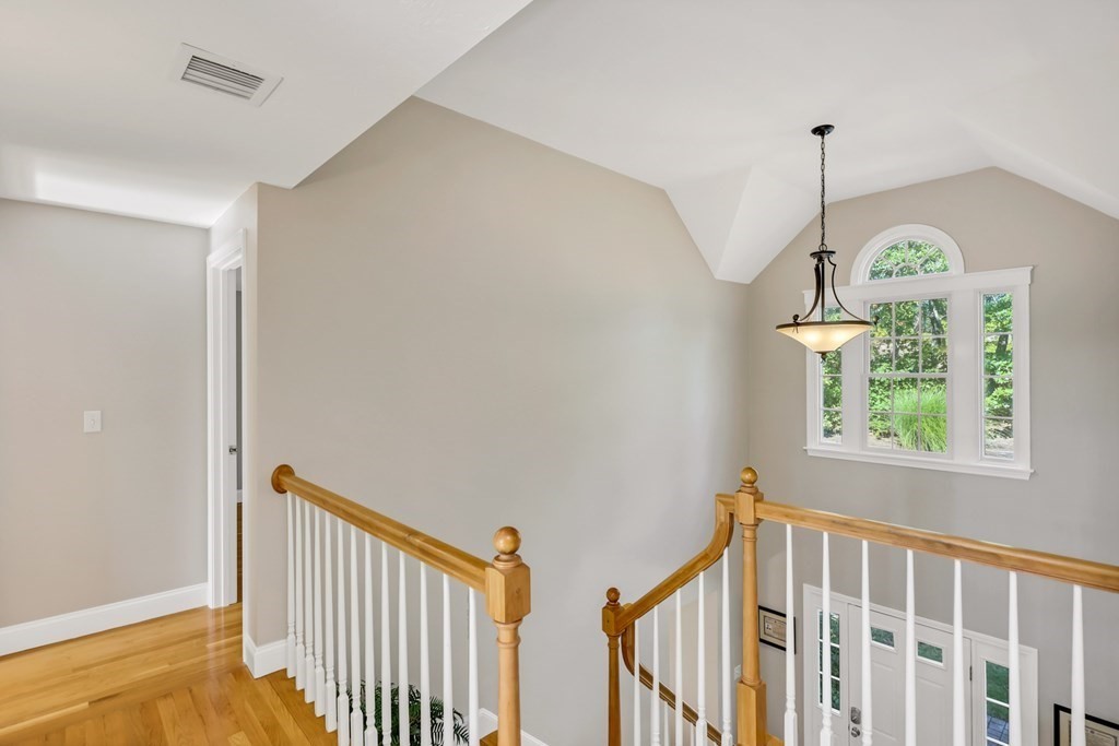 359 Service Road East Sandwich, MA 02537 - Photo 19 of 36 a view of hallway with wooden floor and a chandelier