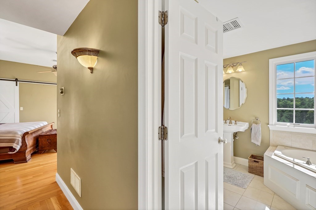 359 Service Road East Sandwich, MA 02537 - Photo 23 of 36 a en suite bathroom with a sink and a mirror