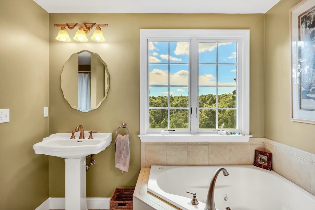 359 Service Road East Sandwich, MA 02537 - Photo 24 of 36 a bathroom with a sink and a mirror