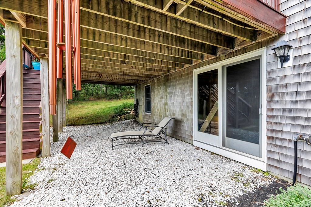 359 Service Road East Sandwich, MA 02537 - Photo 34 of 36 a view of a patio with a table and chairs and plants