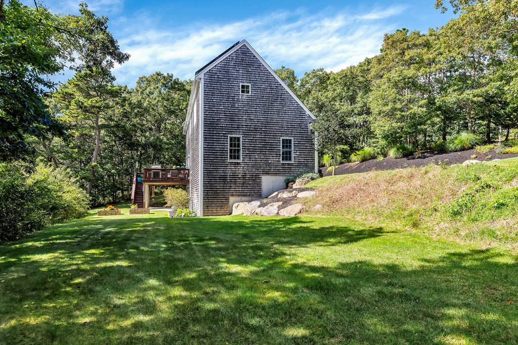 359 Service Road East Sandwich, MA 02537 - Photo 35 of 36 a backyard of a house with table and chairs