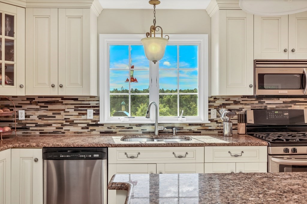 359 Service Road East Sandwich, MA 02537 - Photo 8 of 36 a kitchen with stainless steel appliances granite countertop a stove a sink and a microwave