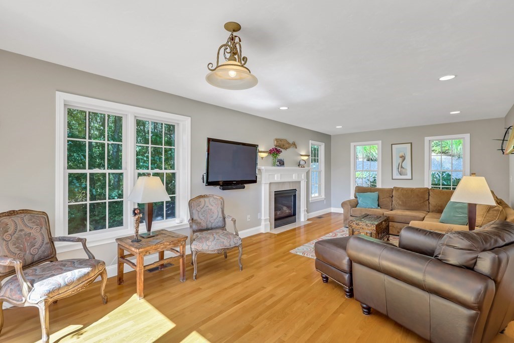 359 Service Road East Sandwich, MA 02537 - Photo 9 of 36 a living room with furniture a fireplace and a flat screen tv